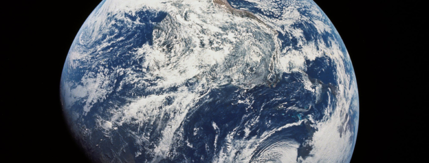 One of the first images taken by humans of the whole Earth. Photographed by the crew of Apollo 8 (probably by Bill Anders) the photo shows the Earth at a distance of about 30,000 km. South is at the top, with South America visible at the covering the top half center, with Africa entering into shadow. North America is in the bottom right.
